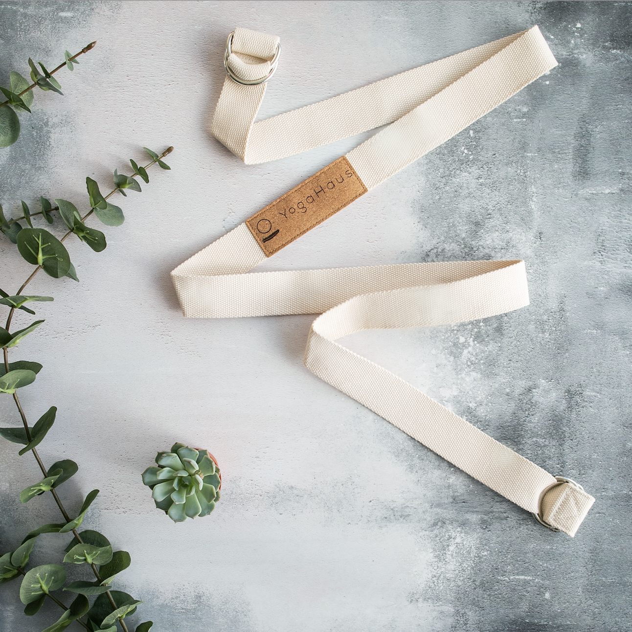 A 2-in-1 cotton yoga mat strap with metal D-ring clasp